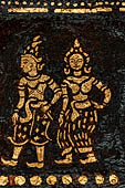 Wat Xieng Thong temple in Luang Prabang, Laos. Detail of the  intricate gold stencilling on black lacquer that decorate the walls of the sim. 